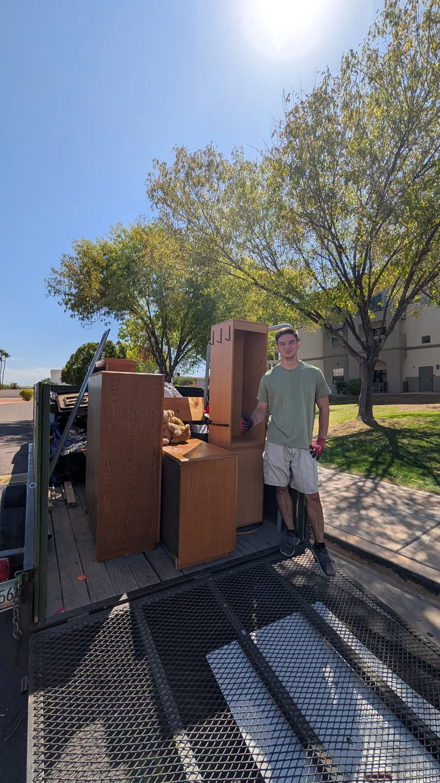 Wood dresser positioned at the trailer during furniture removal in Sun City