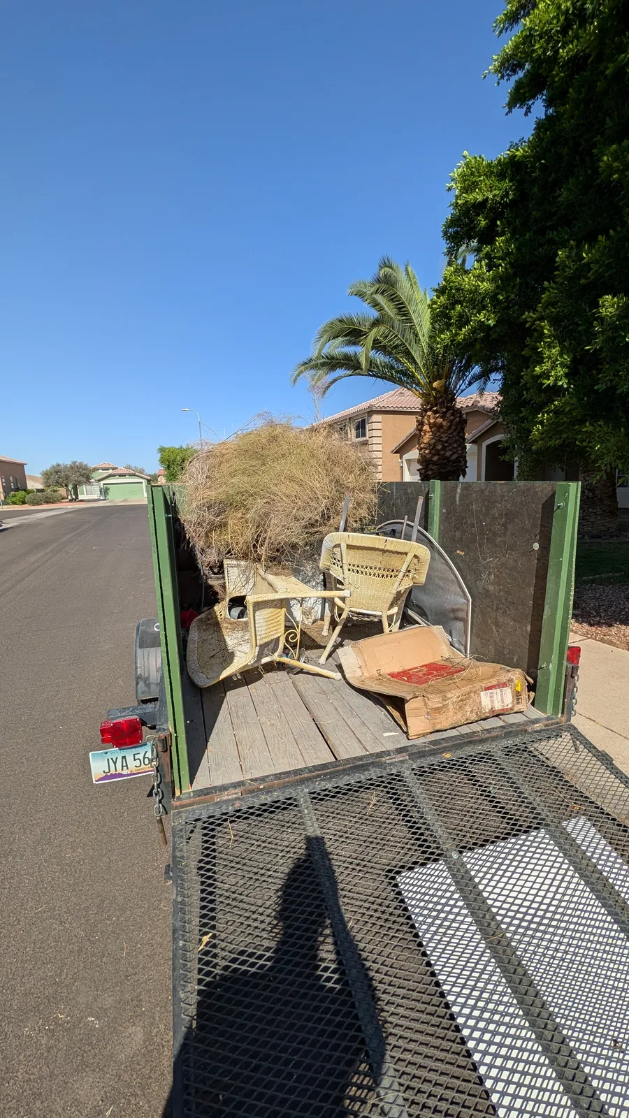 Brush, patio chairs, and bulky junk in a Peoria removal trailer