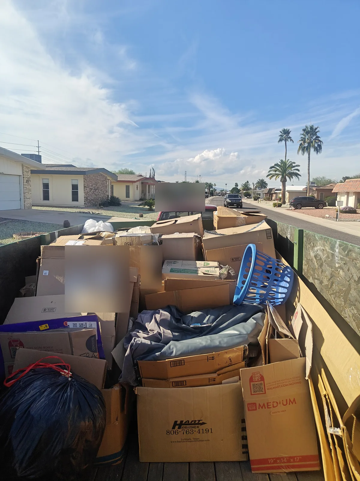 Cardboard boxes and mixed household junk loaded in Sun City