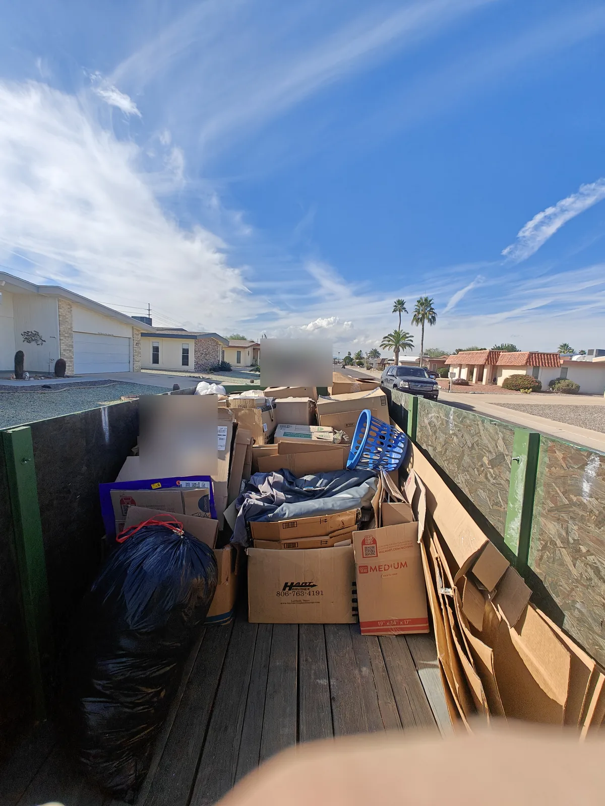 Wide view of a nearly full household junk trailer in Sun City