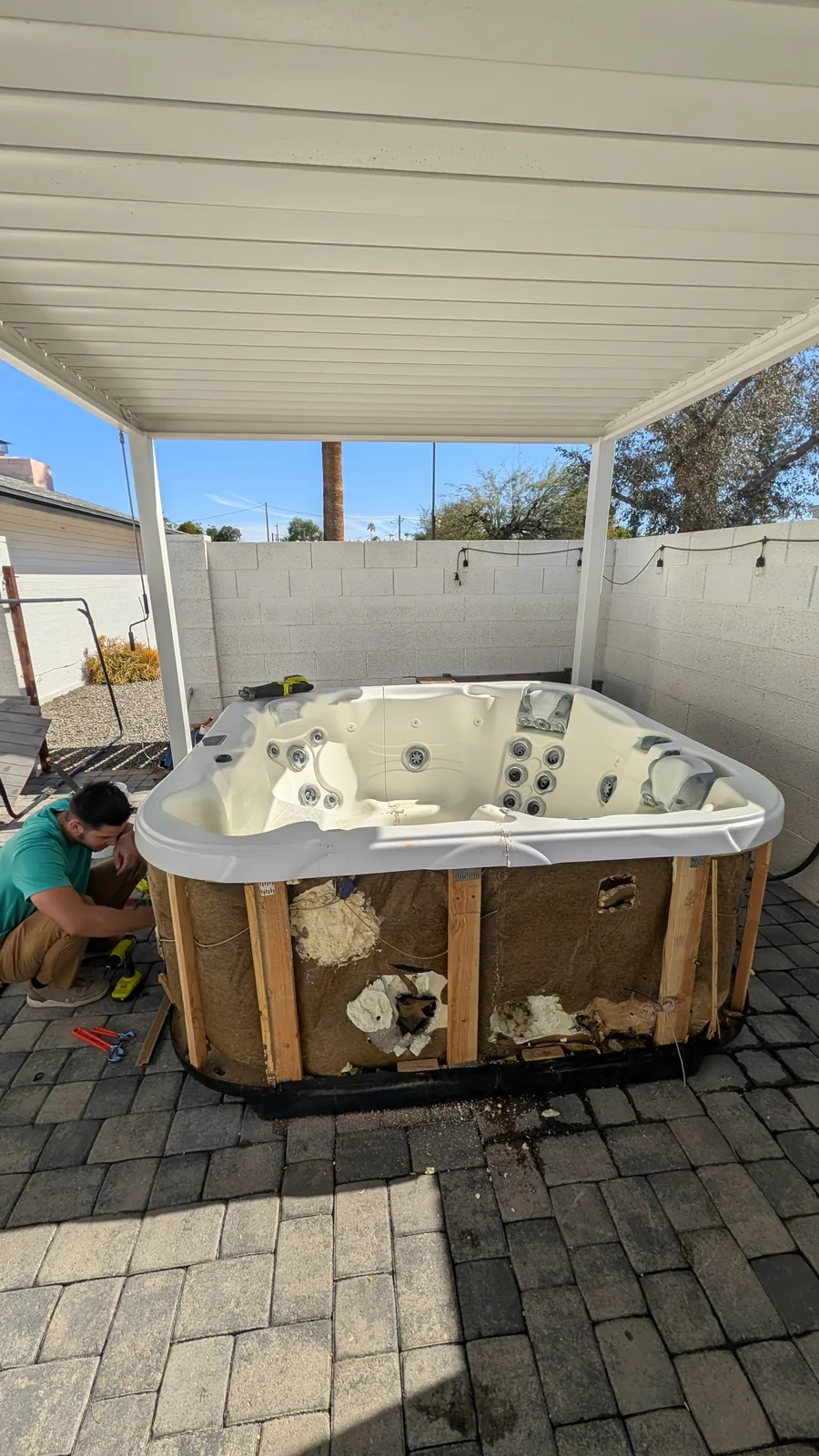 Opened hot tub cabinet during removal under a Phoenix patio cover