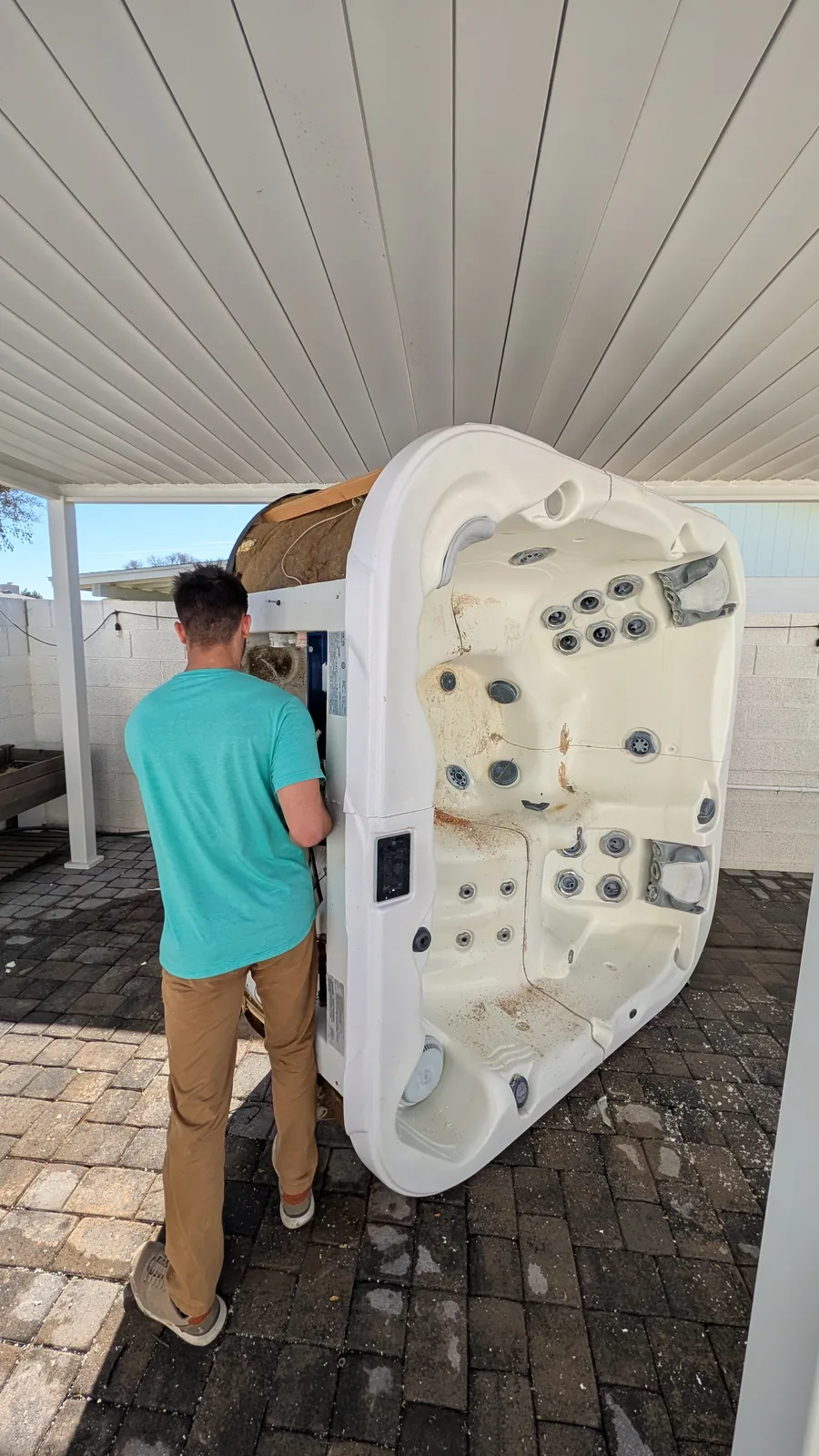 Hot tub shell positioned upright during removal in Phoenix