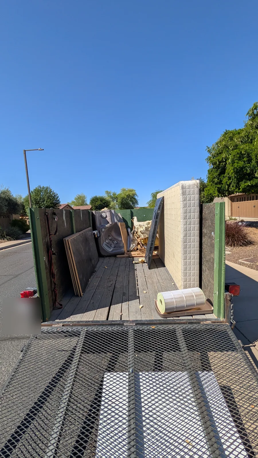 Mattress and hot tub parts arranged during a Peoria removal