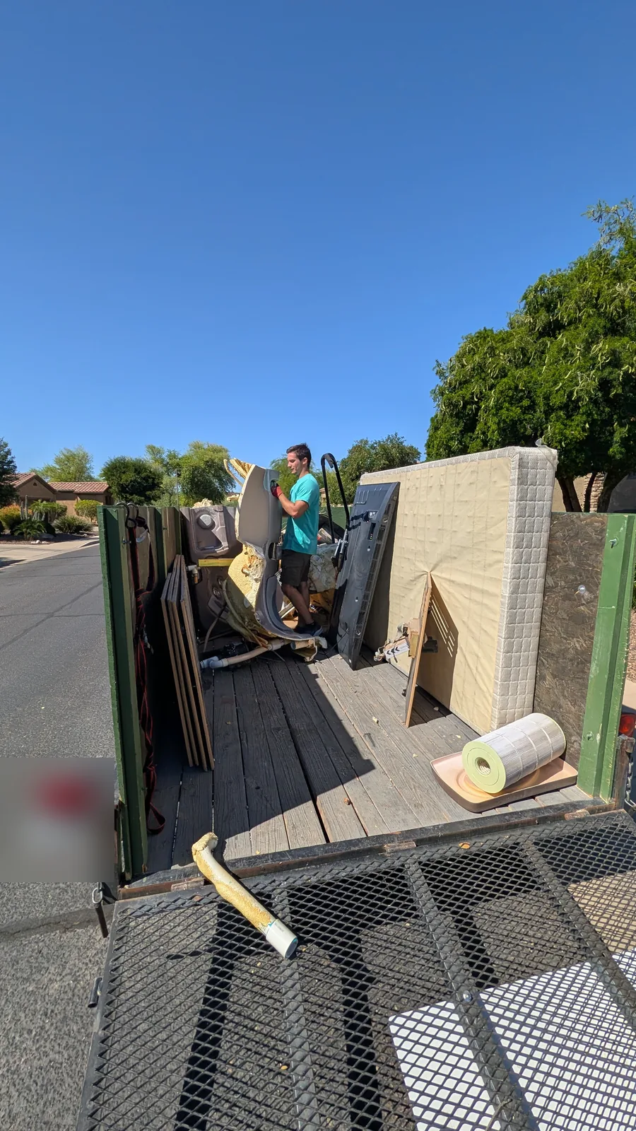 Dismantled spa material and mattress loaded for removal in Peoria