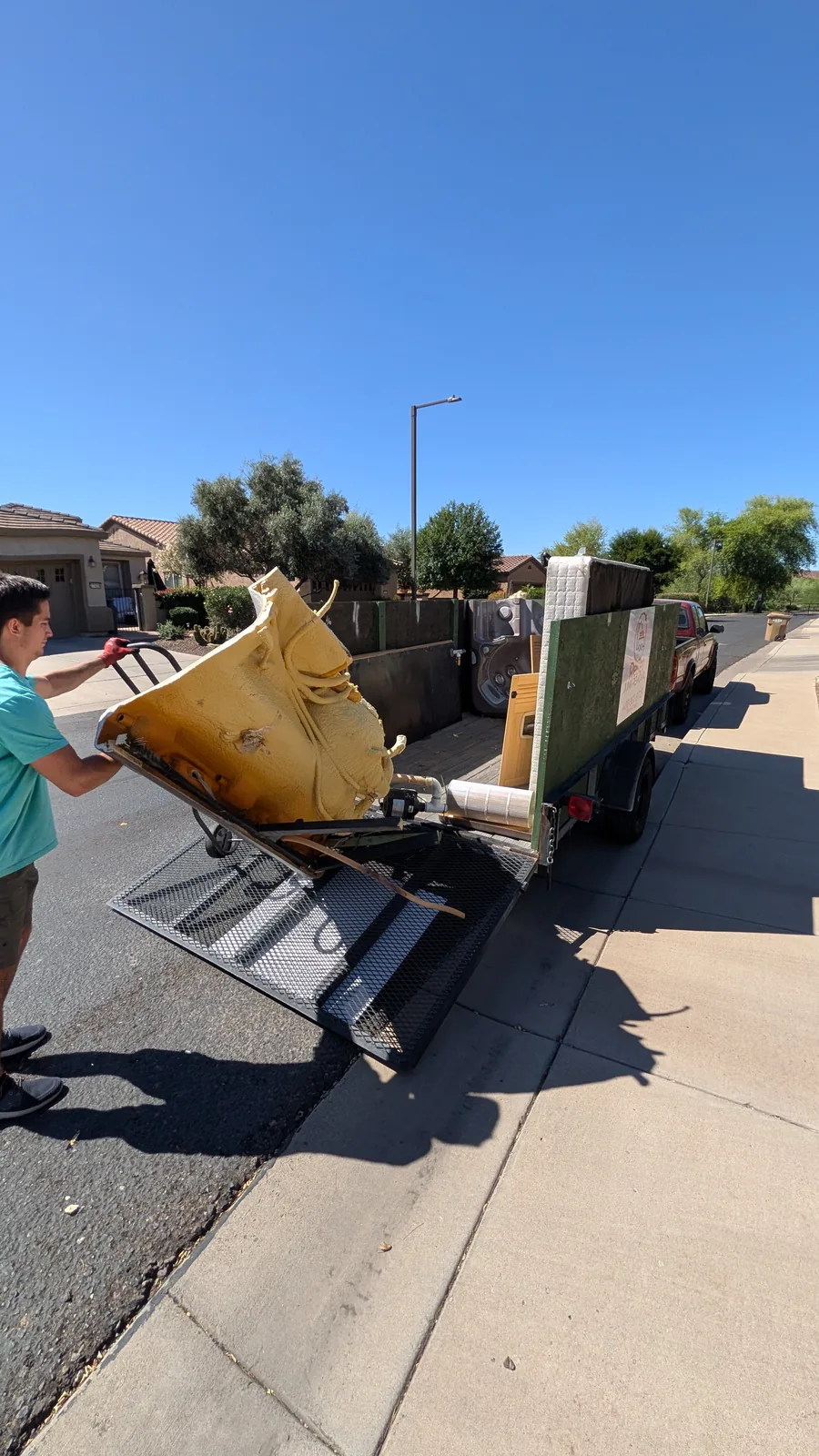 Hot tub shell section being moved toward the trailer in Peoria
