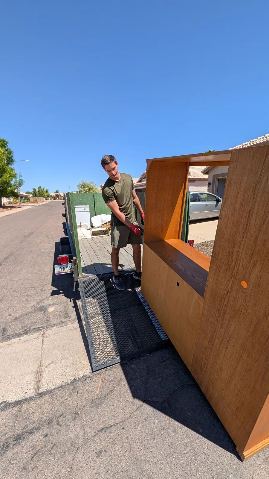 Wood entertainment center on the trailer during Peoria furniture removal