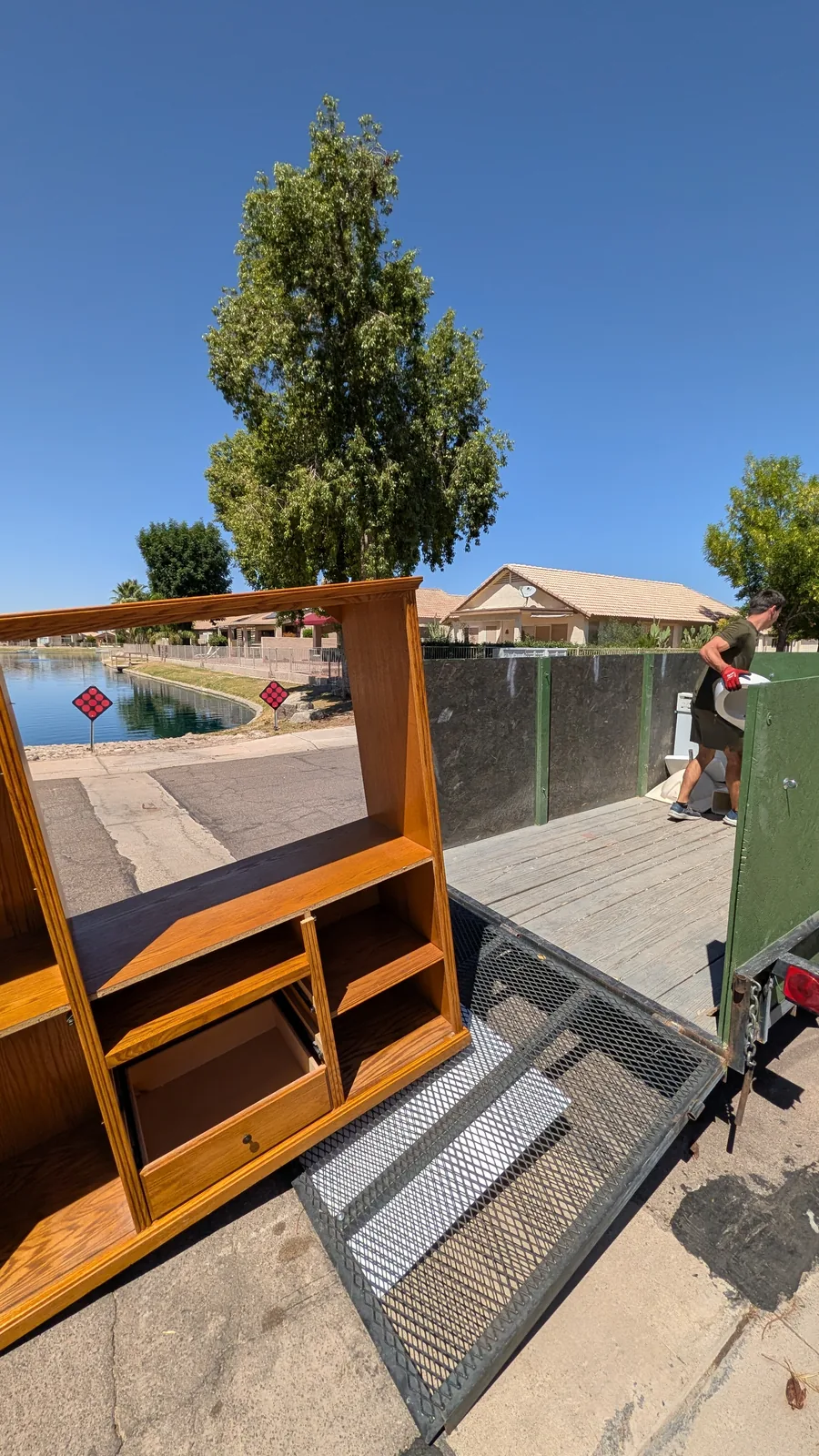 Side view of a wood entertainment center during loading in Peoria