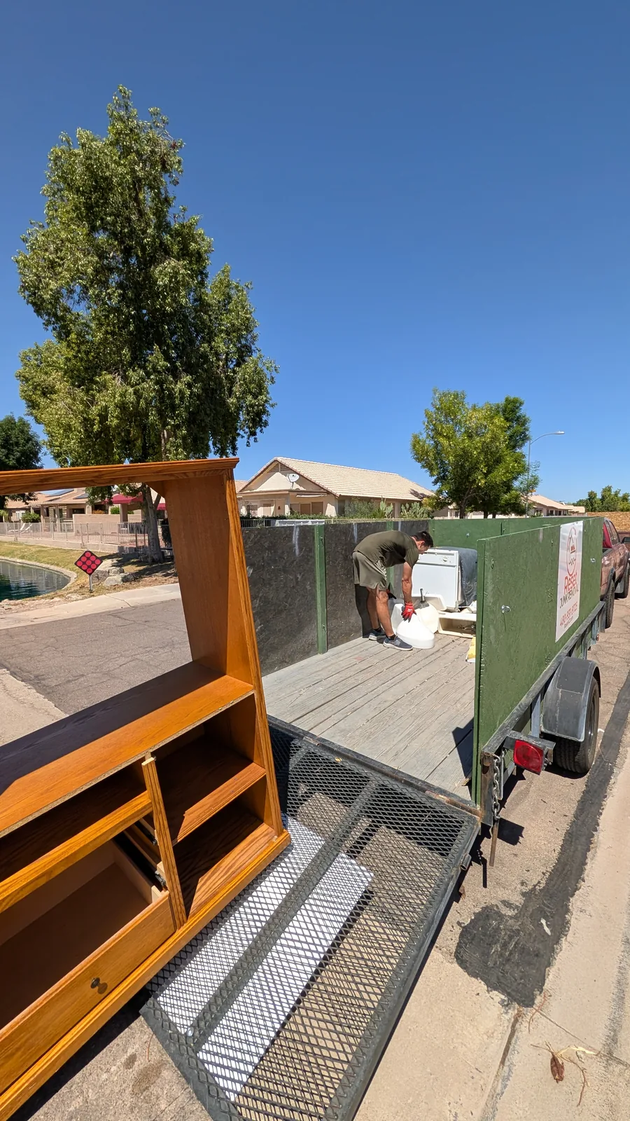 Large entertainment center being moved onto the trailer