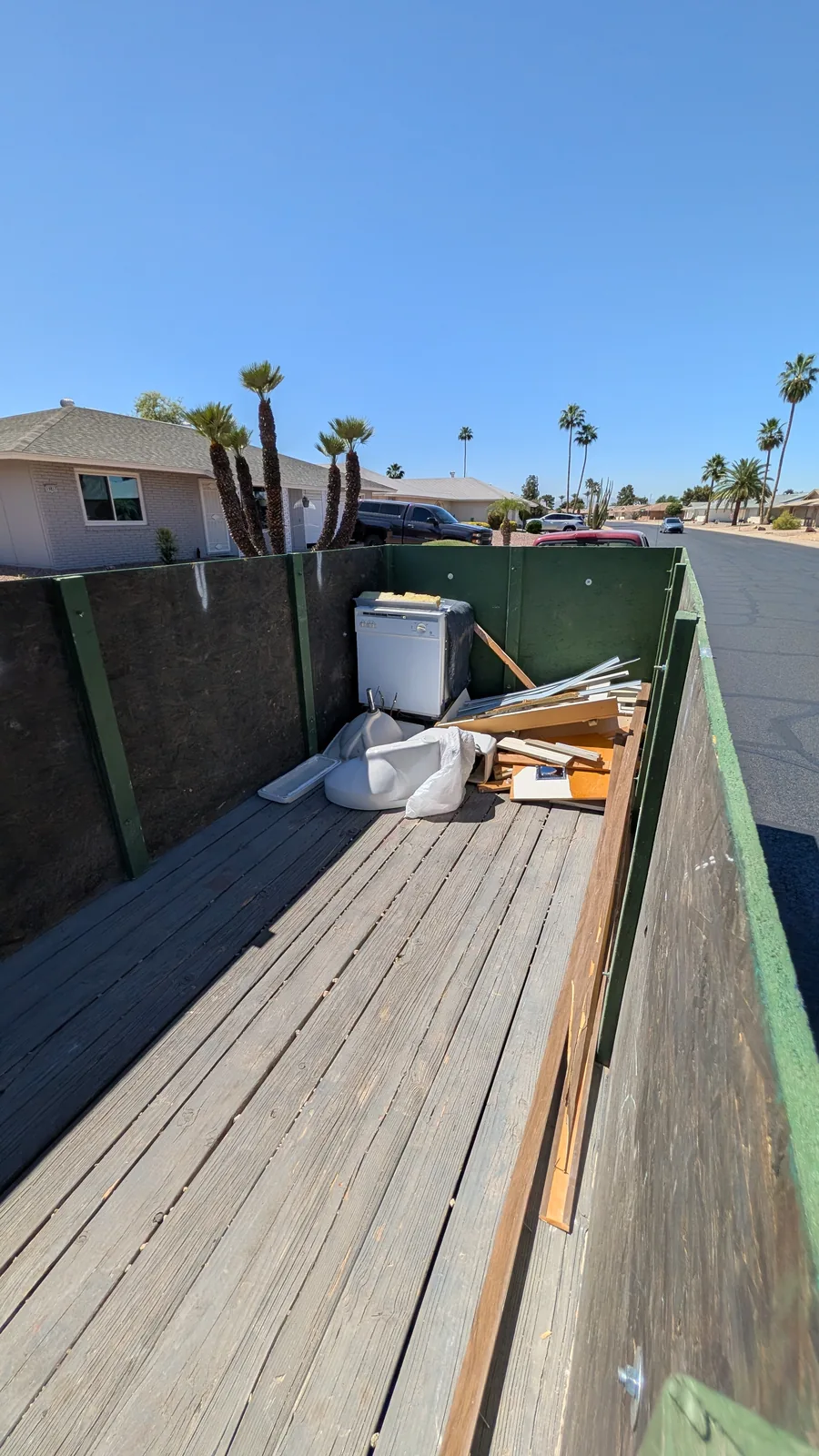 Cabinet, trim, and renovation debris arranged in the trailer