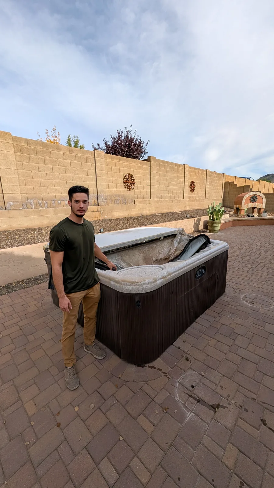 Hot tub before removal from a paved backyard in North Phoenix