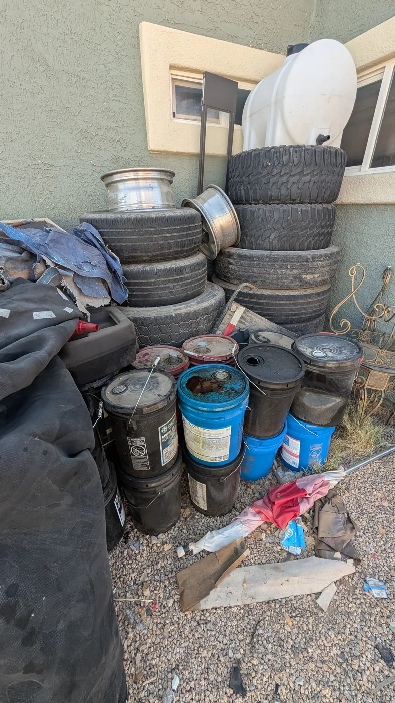 Tires, buckets, and household items prepared for junk removal in Peoria