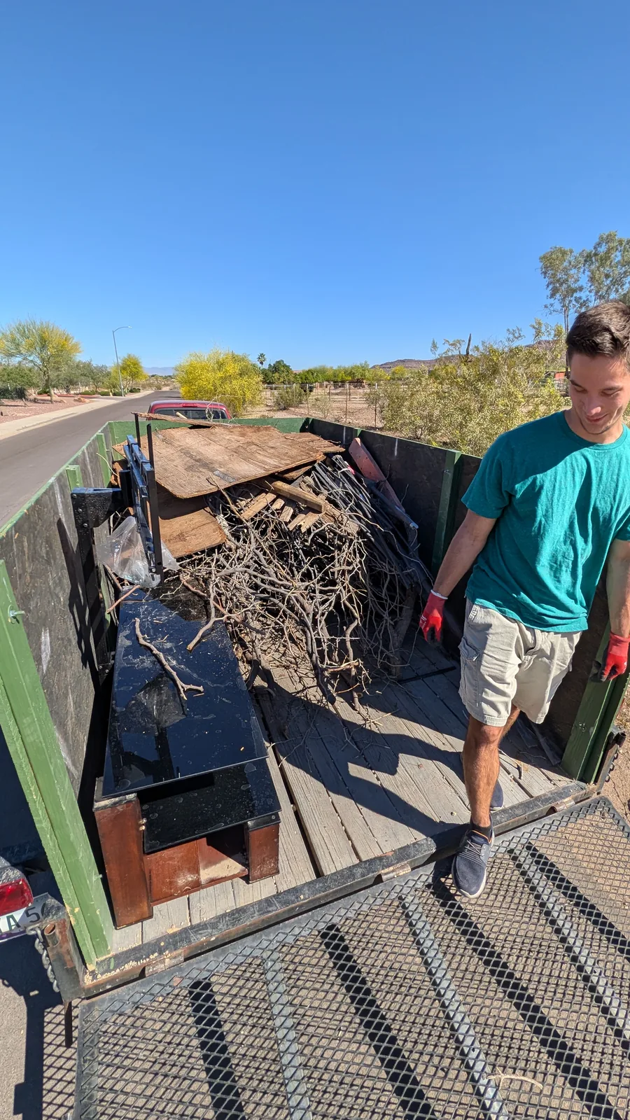 Trailer filled with branches, bags, and furniture during a Peoria pickup