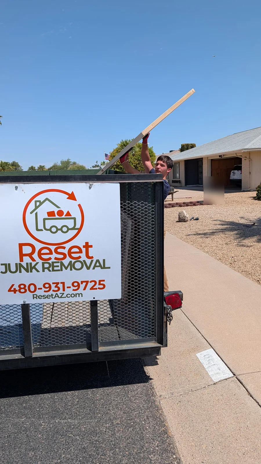 Long household item being moved to the Reset trailer in Sun City