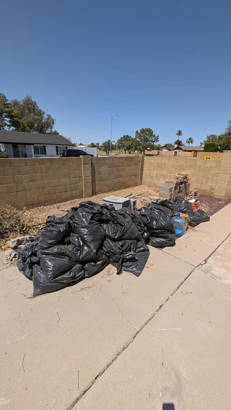 Large pile of bagged yard waste before removal in North Phoenix